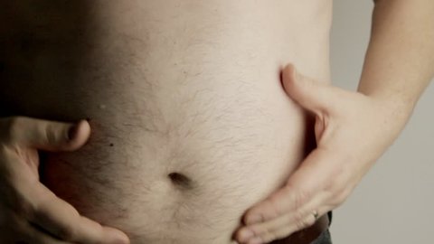 Man feeling his belly
