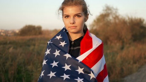 Patriotic Proud Beautiful young woman with American USA stars and stripes flag. freedom and memorial concept Stockvideó