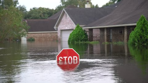 Houston, Texas - United States - August 27, 2017: Flood water reaches the level of a street sign during hurricane Harvey