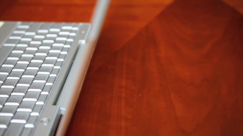 Man (43 yr) typing on a laptop computer, pan