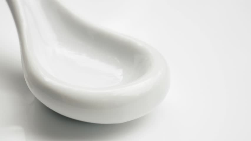 Various colorful medicine Pills Falling Into white Spoon. Healthy Multivitamin pills. Nutritional supplements.