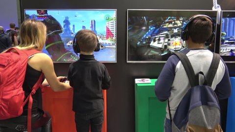 Moscow, Russia - September, 2017: Boys in headphones playing video computer game on IGROMIR (Games World) and Comic Con Russia 2017 in Moscow, Russia