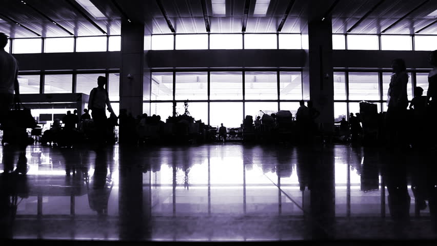 Passengers walking and waiting in international terminal hall