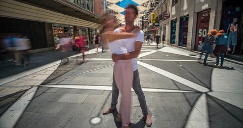 Time lapse of couple of lovers kissing while the people move speedly