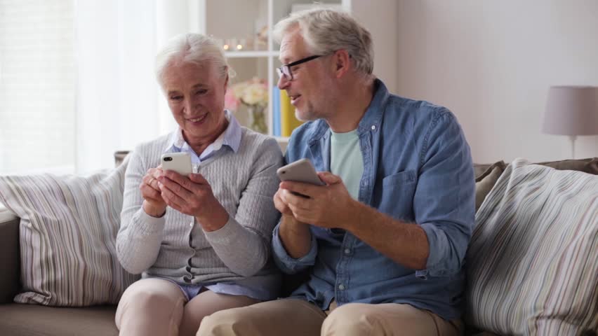 Family, technology, age and people concept - happy senior couple with smartphones at home | Shutterstock HD Video #32137414