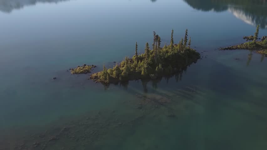 Aerial landscape view of the beautiful rocky islands in glacier lake with mountains in the background. Picture taken in Garibaldi near Squamish, North of Vancouver, British Columbia, Canada.