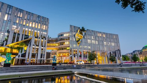 DUSSELDORF, GERMANY - JUL 5, 2017: Evening view of the Ko-Bogen. Ko-Bogen is a mixed used building, designed by New York architect Daniel Libeskind. Düsseldorf, Germany on July 5, 2017. Timelapse 4K.