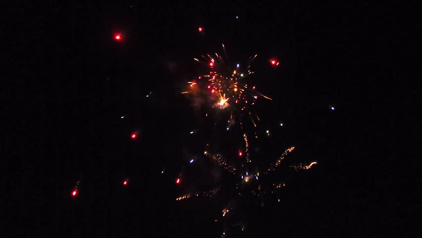 Celebration of lighting off fireworks at night.