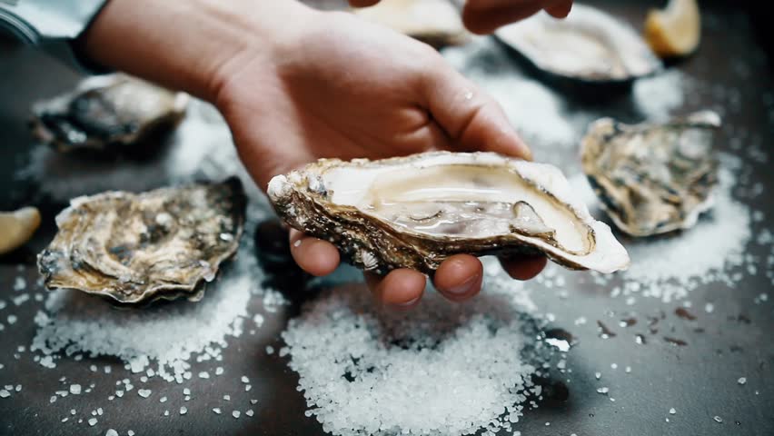 Open oyster with lemon juice | Shutterstock HD Video #32153176