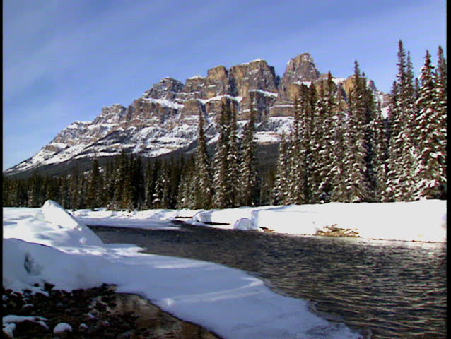 Zoom in to Castle Mountain winter scene of Bow River in Banff National Park