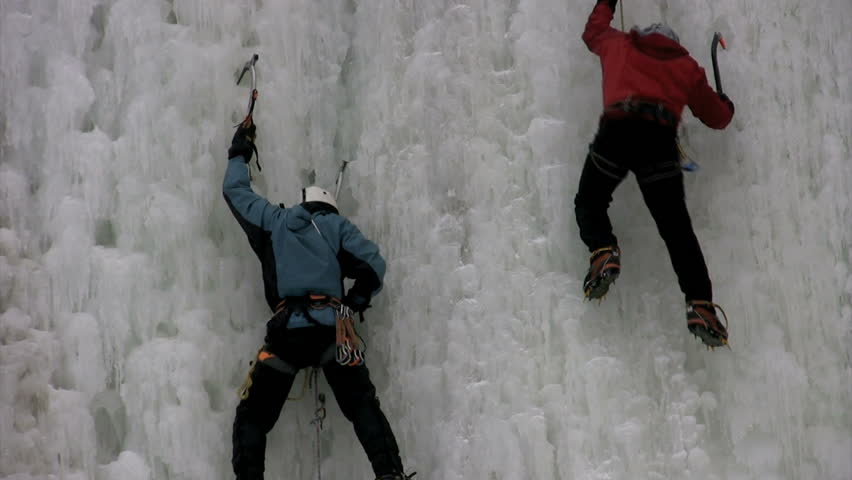 close up of two men ice climbing