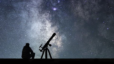 Man with astronomy telescope looking at the stars. Man telescope and starry sky. Night sky. Milky way galaxy Time Lapse.