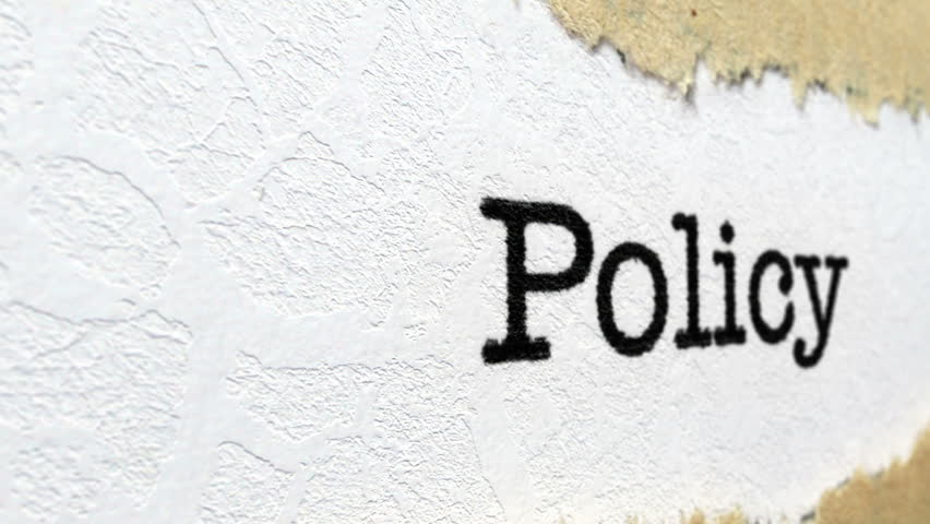 Policy text on torn paper