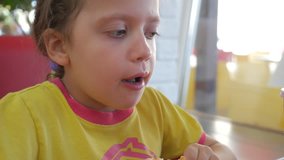 Girl eating pizza in a cafe, close-up slow motion