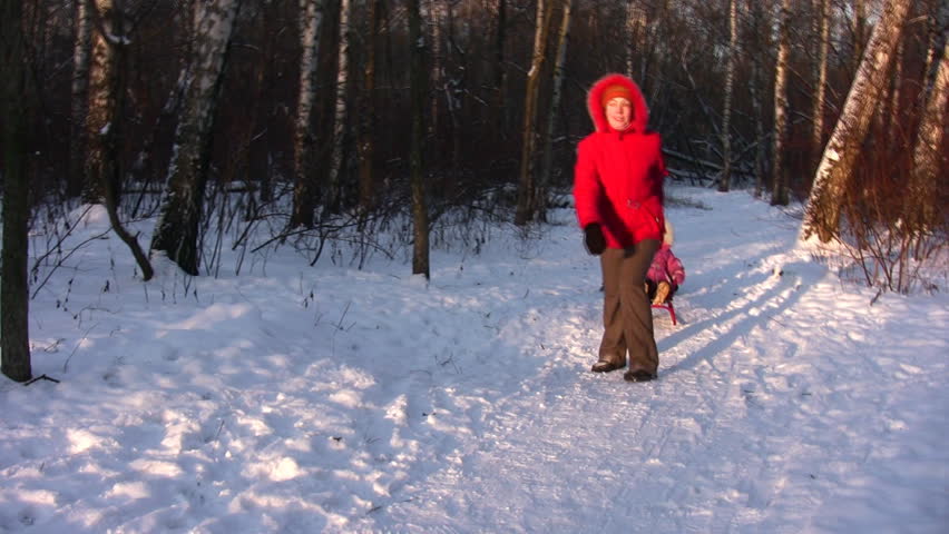 Mother with children on sled 