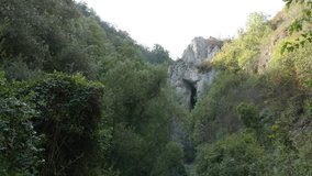Arch of natural stone bridge 4K 2160p 30fps UltraHD tilting  footage - Slow tilt on wild nature of Eastern Serbia 3840X2160 UHD video