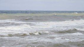 Storm wind raises waves. Hurricane on the sea. Ocean waves storm sea spray.