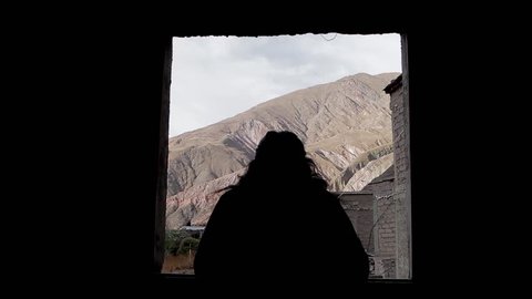 Woman Opens a Window in Iruya, a Remote Argentine Village in the Altiplano, and Looks Out. 