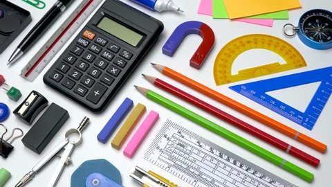 School office stationery supplies flat-lay on white table background top view. School supplies for STEM education Science, Technology, Engineer and Mathematics.