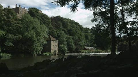 Durham, England, The River Wear at Prebends Bridge filmed downstream of the weir. 4K