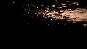 The Metal Sparks stock video clip has sow motion footage of metal sparks flying in the air over a black background. Drop it in and change its blending mode to remove the black background.