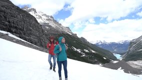 Young couple hiking on glacier in Canada, Lake Louise on background.
People exploration nature sharing concept