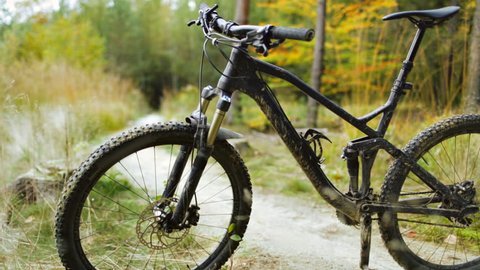 Mountain bike on bicycle trail in autumn forest. Slider stabilized video shot with Canon 5D mark III.