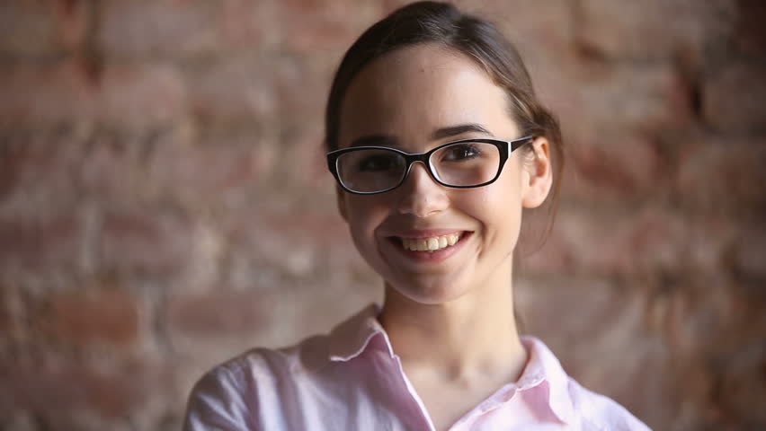 Young girl in glasses looking at camera, motivated student with big dreams studying abroad, ambitious smiling millennial posing indoors, creative happy manager starts successful career, optical shop Royalty-Free Stock Footage #32239312