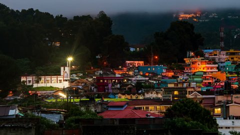 Ooty, India time-lapse from evening to night. Aerial view of Nilgiri mountain village in Tamil Nadu, India. Ooty is a popular resort with beautiful nature. Zoom out