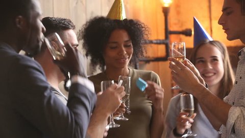 Multi-ethnic students enjoying celebration, diverse young african american and caucasian friends hanging out drinking champagne dancing together, colleagues having fun entertaining at staff party Stock Video