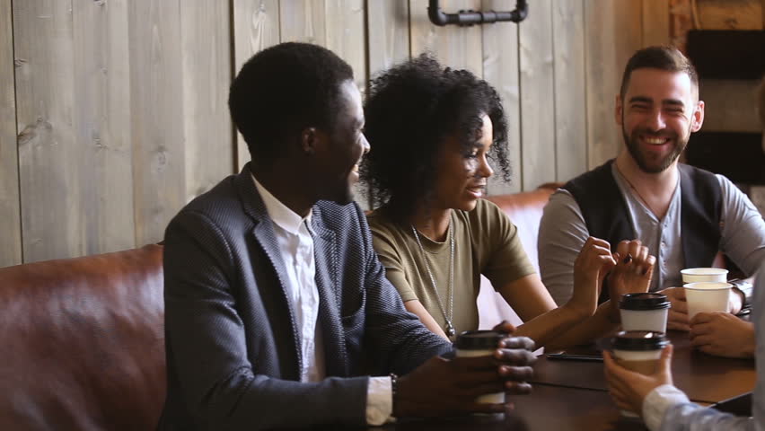 Diverse young guys spending time together in cafe, multinational close best friends talking and laughing at meeting in cafeteria, positive mates enjoying hanging out together relaxing in coffee house Royalty-Free Stock Footage #32241931