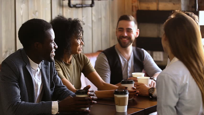 Multiracial friends drinking coffee together in cozy cafe, mixed race buddies talking sharing news having fun at meeting in cafeteria, diverse millennials chatting spending time in bar after work Royalty-Free Stock Footage #32241940