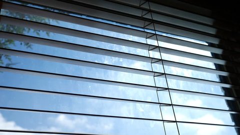 Cinematic Blue Cloud Timelapse outside office blinds