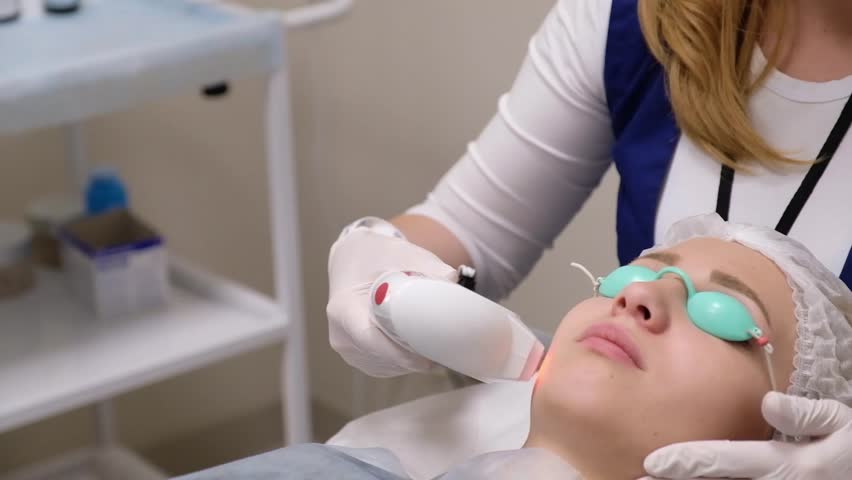Woman having a laser skin treatment in a skincare clinic, a resurfacing technique for wrinkles, scars and solar damage to the skin of her face | Shutterstock HD Video #32244970
