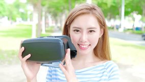 video of beauty woman use VR happily in the park