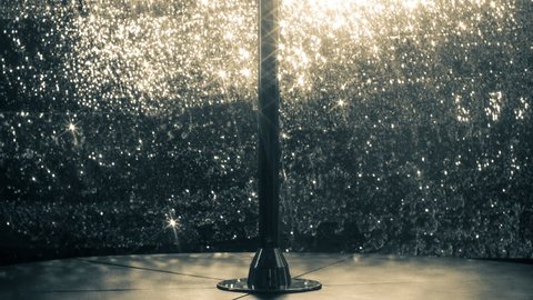a pole in a club or pole dance studio with a sparkling background