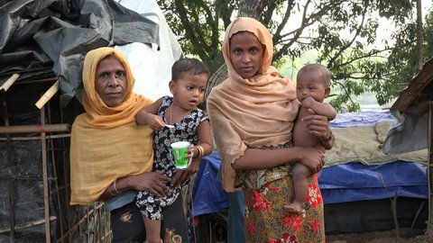 TEKNAF, BANGLADESH - OCTOBER 25, 2017: A group of Rohingya refugee women from Myanmar are standing in a group and looking helpless in the camera