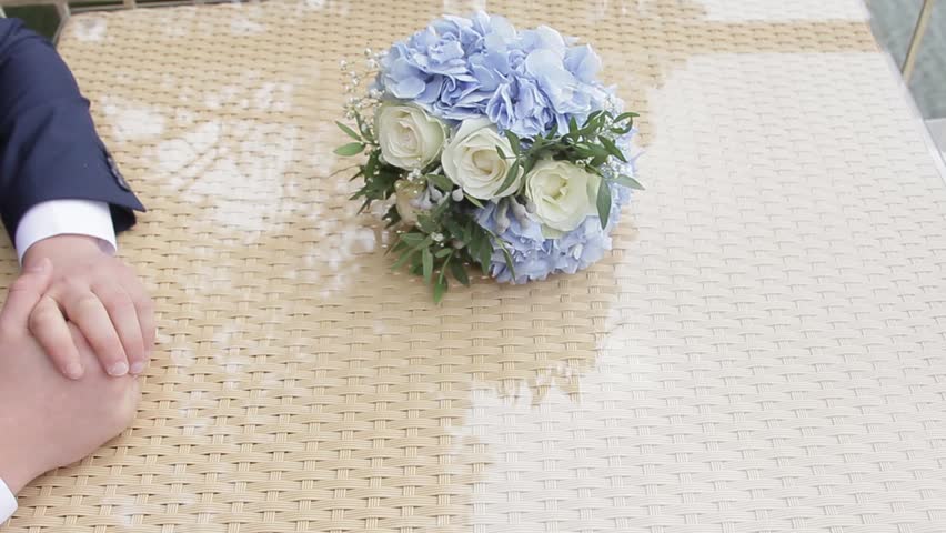 Newlyweds take each other's hands