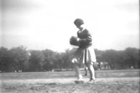 CIRCA 1930s - A girl pitches strikeouts and hits a home run in a baseball game, in Brooklyn, New York, in 1932.