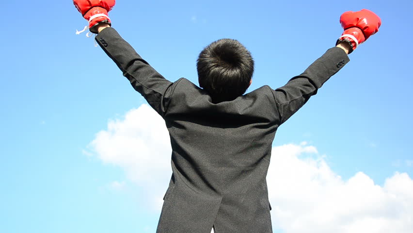 businessman and hand boxing glove ready to fight over blue sky