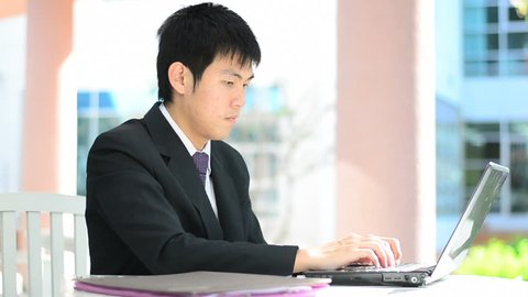 businessman looking at computer screen and has good news