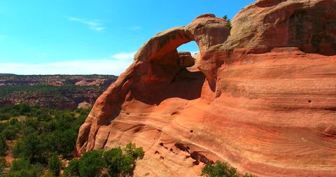 Red Sandstone Arch Against Blue Sky In Desert Landscape - Moving Aerial Shot - Rattlesnake Arches In Colorado, USA