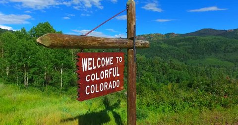 Welcome To Colorful Colorado Road Sign - Aerial Fly-Over Approaching View - Colorado, USA