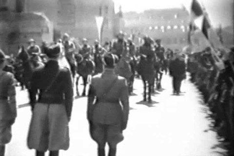 CIRCA 1930s - Prime Minister Benito Amilcare Andrea Mussolini watches members of the Fascist youth march in Rome, Italy, in 1933.