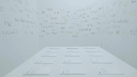 Colorful formulas of chemical elements on walls at white office and white table. Chemical formulas written on white chalkboard. Chemical Bonding Experiment Research Science Table of Elements Concept - Powered by Shutterstock - Get 15% off with code: PIKWIZARD15