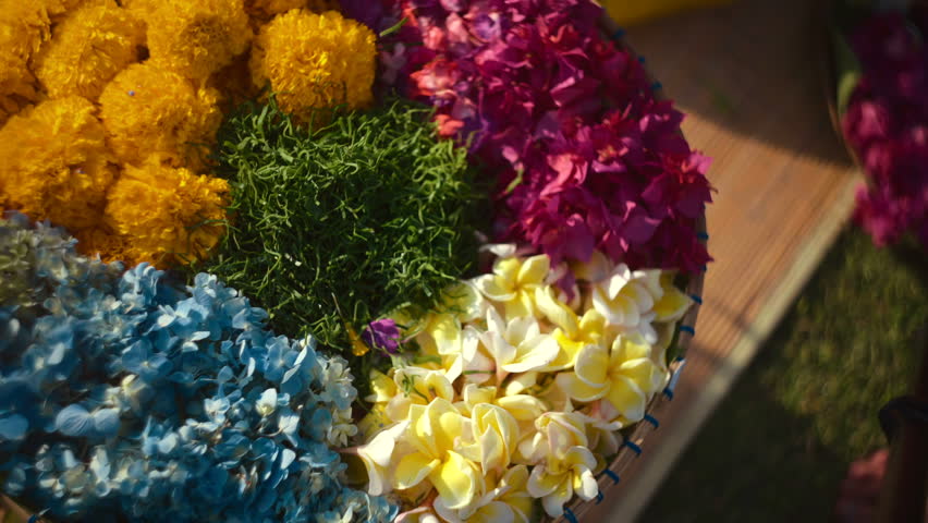 Close up of woman hand taking flowers from tray to make offerings