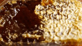 4k, slow motion. someone opens the beeswax with a honeycomb spoon. blur. background
