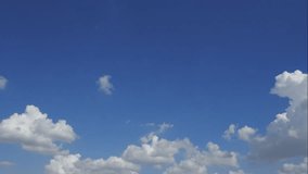 Time lapse of timelapse of bue sky with white cloud. Royalty high-quality stock video footage of time lapse bright blue sky white fluffy clouds on clear sunny day. Natural cloudscape background