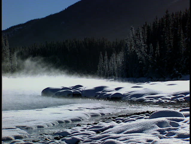 Winter mist rising from the Bow River in Banff National Park Canada
