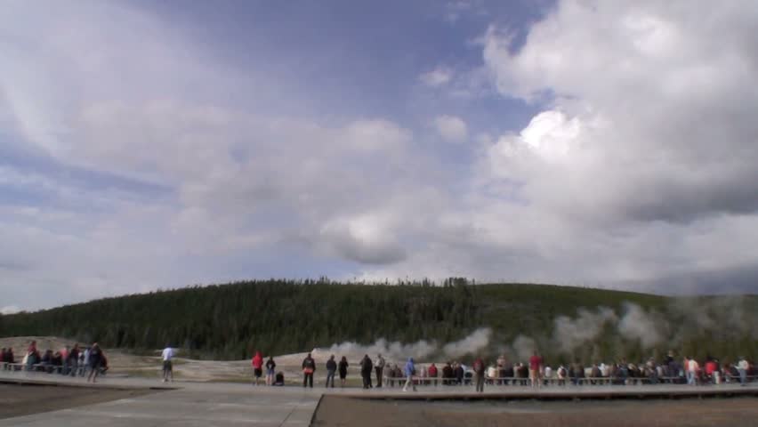 Time-lapse of Old Faithful erupting with tourists looking on - Yellowstone National Park, Wyoming